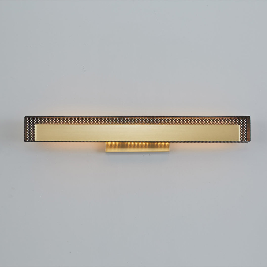 Sleek gold wall picture light with perforated detail, viewed from above.