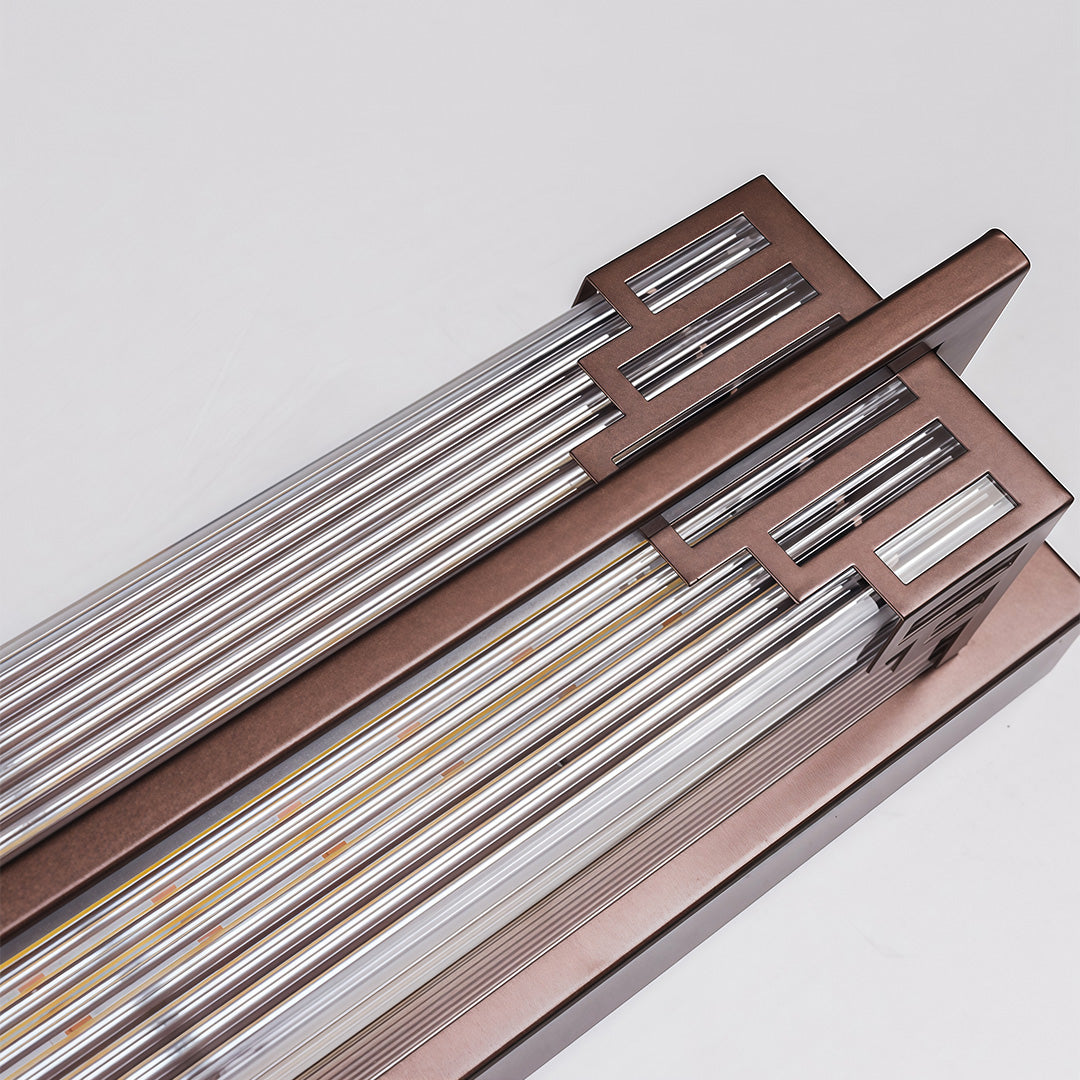 Sleek outdoor wall mounted LED lights with a golden finish, installed to light up a front entrance wall.