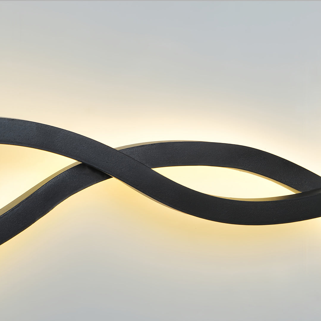 Detailed view of the sleek, intersecting lines of the contemporary black bedside wall light design.