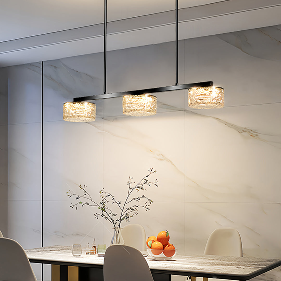 Stylish LED linear pendant light illuminating sleek kitchen design with integrated appliances and cabinetry