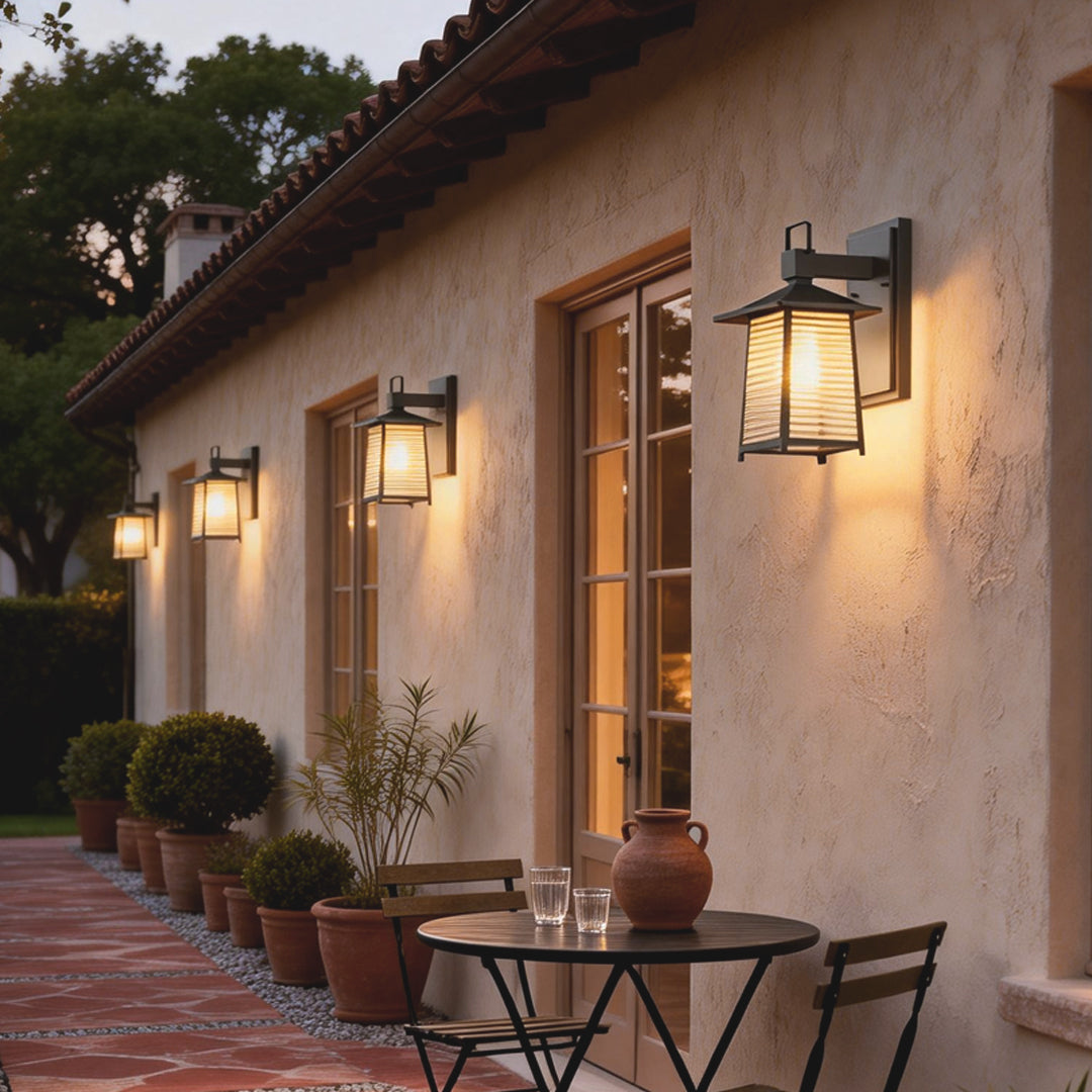 Sleek lantern outdoor wall light mounted beside a wooden door, enhancing the entrance with soft illumination.