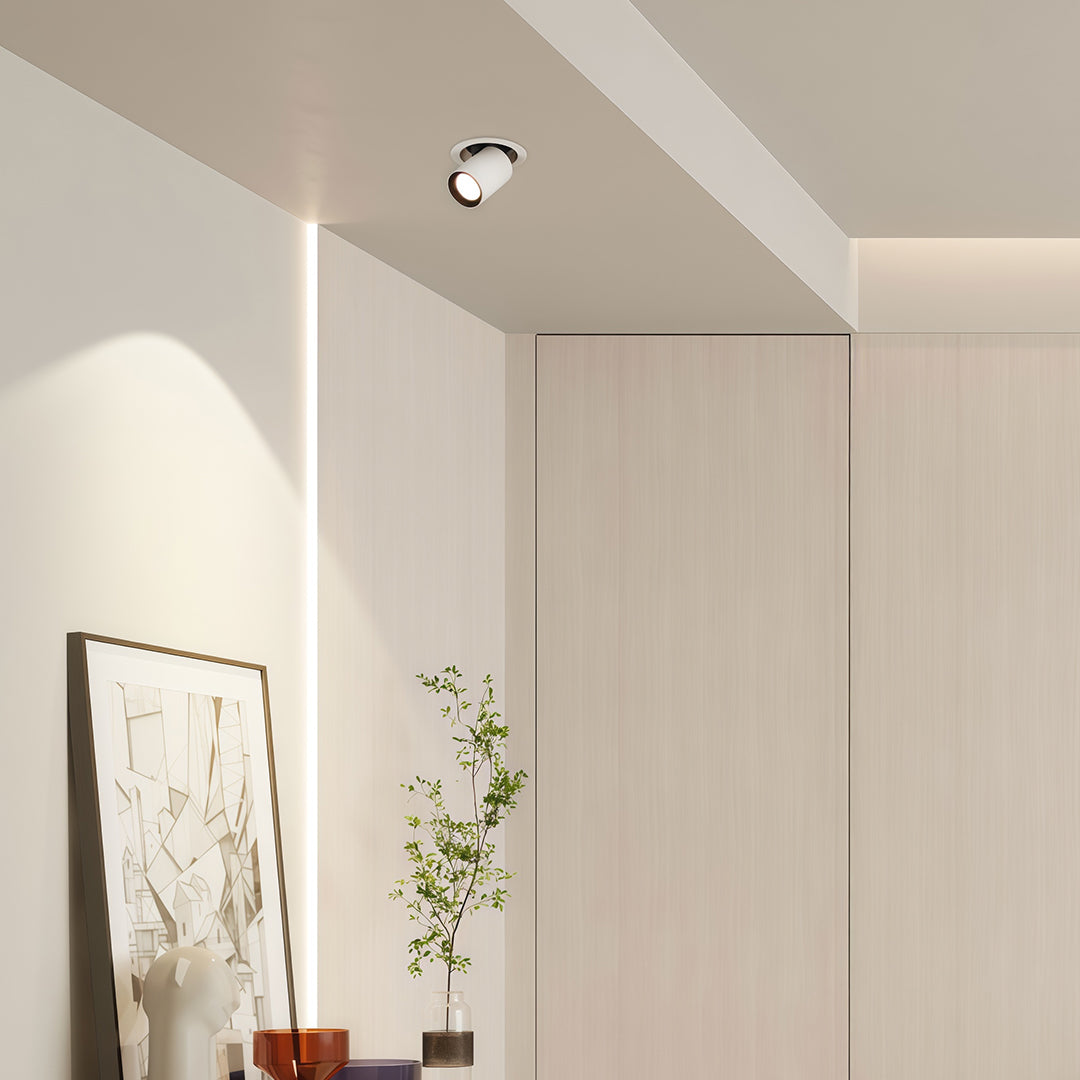 Sleek LED indoor spotlights creating warm ambiance in minimalist hallway with glass shade chandelier influenced design.