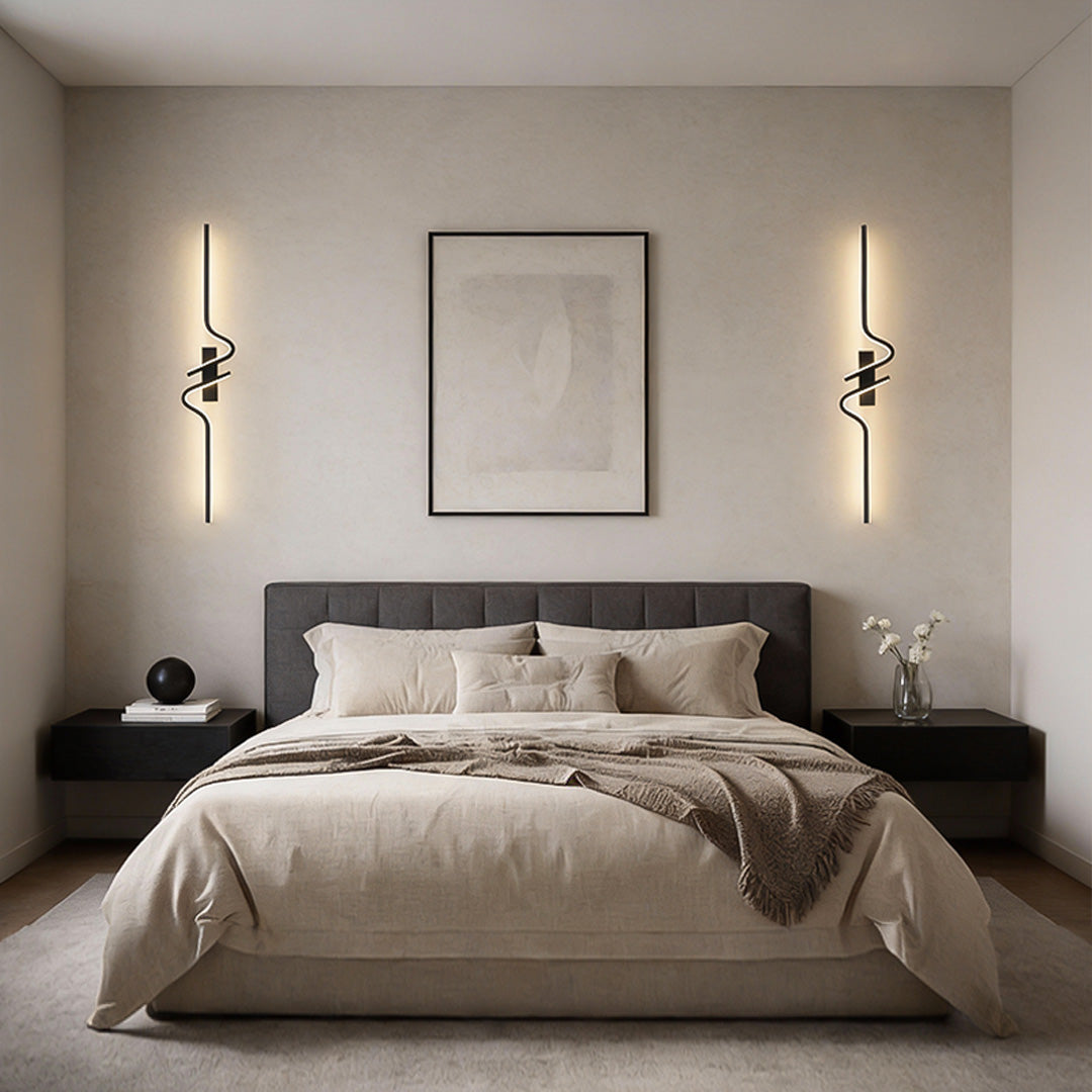 Sleek modern curved wall sconce in black finish, providing ambient lighting for modern interiors like bedrooms or hallways.