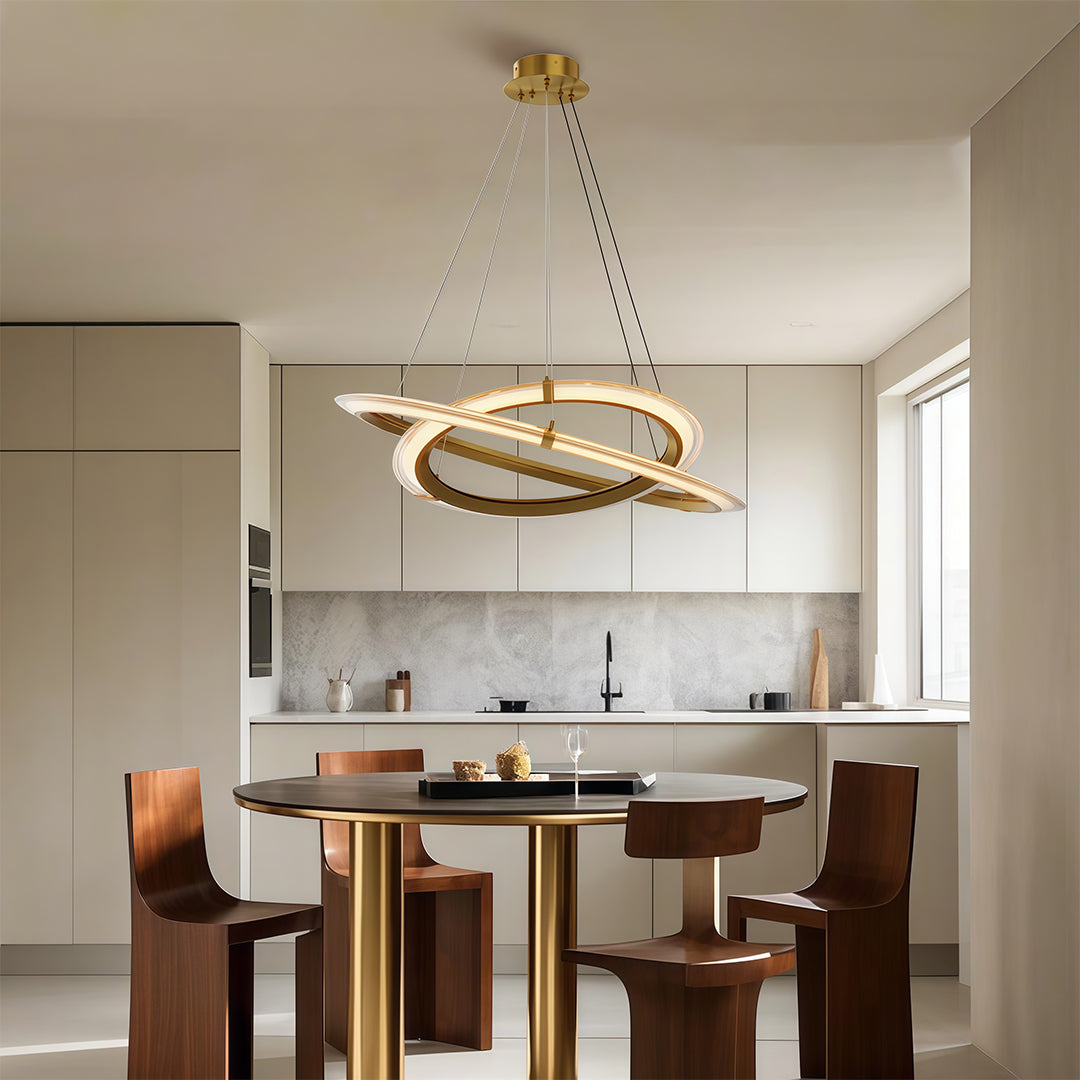 Sleek modern round chandelier with dual circular rings, hanging above a dining table in a contemporary kitchen.