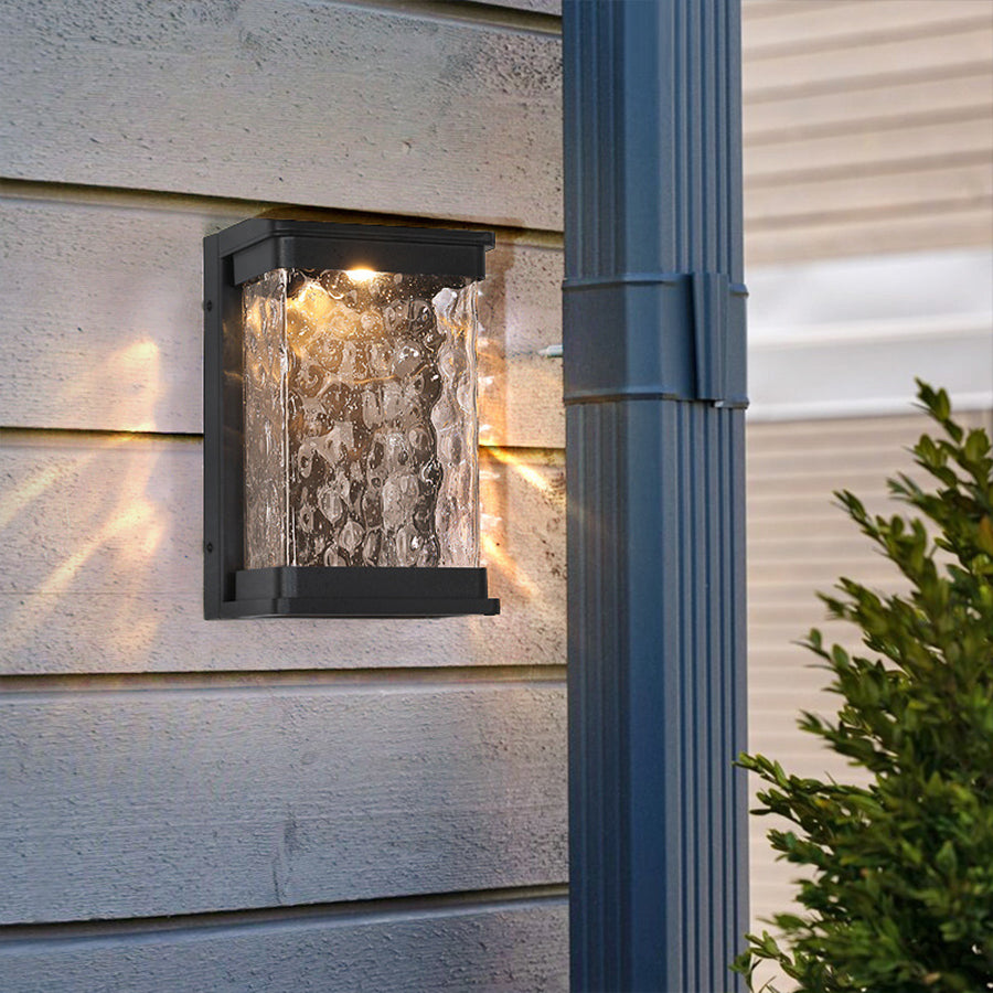 Sleek outdoor lighting fixture with crystal-like glass creating ambient illumination on modern home