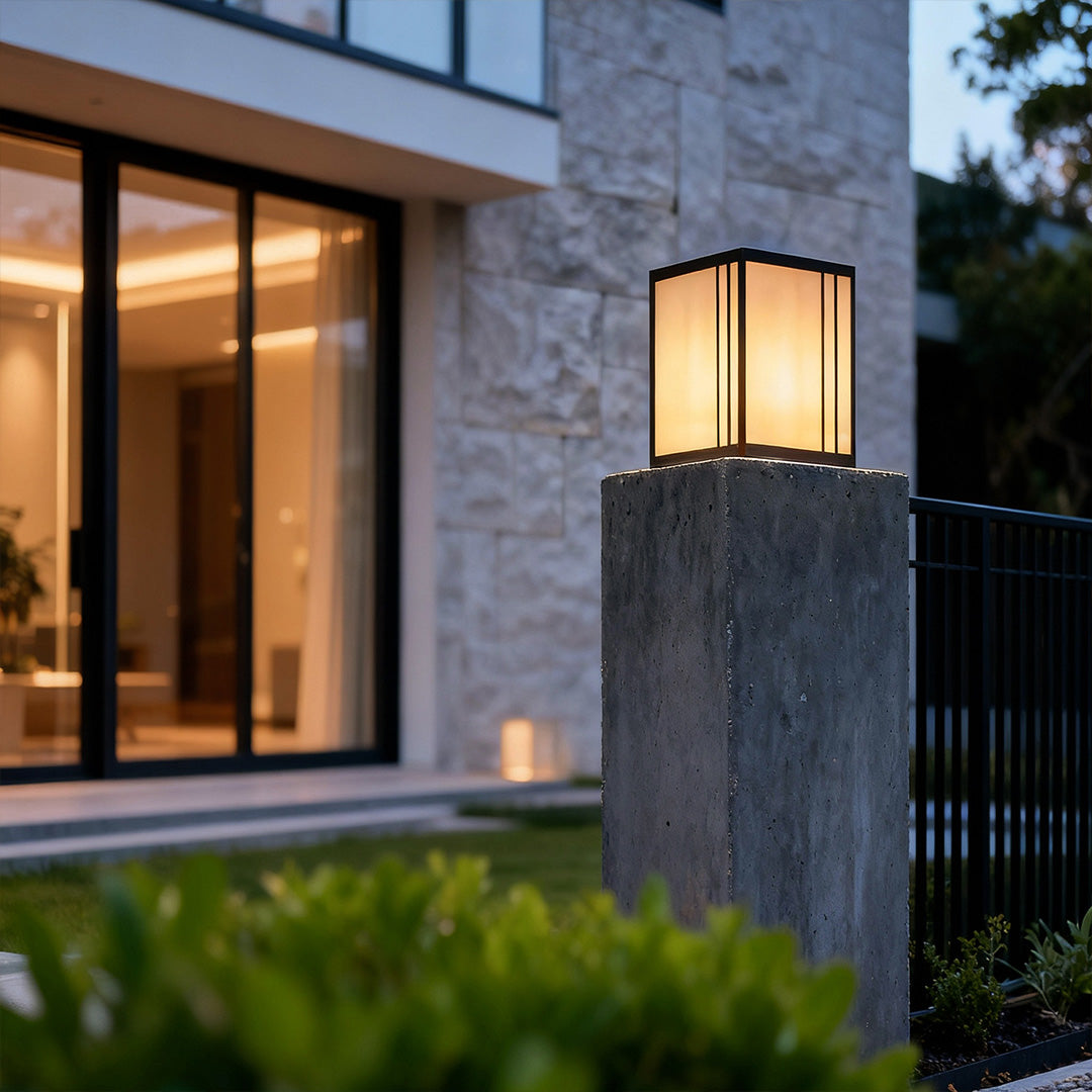 Sleek outdoor pillar lights LED enhancing the entrance of a contemporary house with warm lighting.
