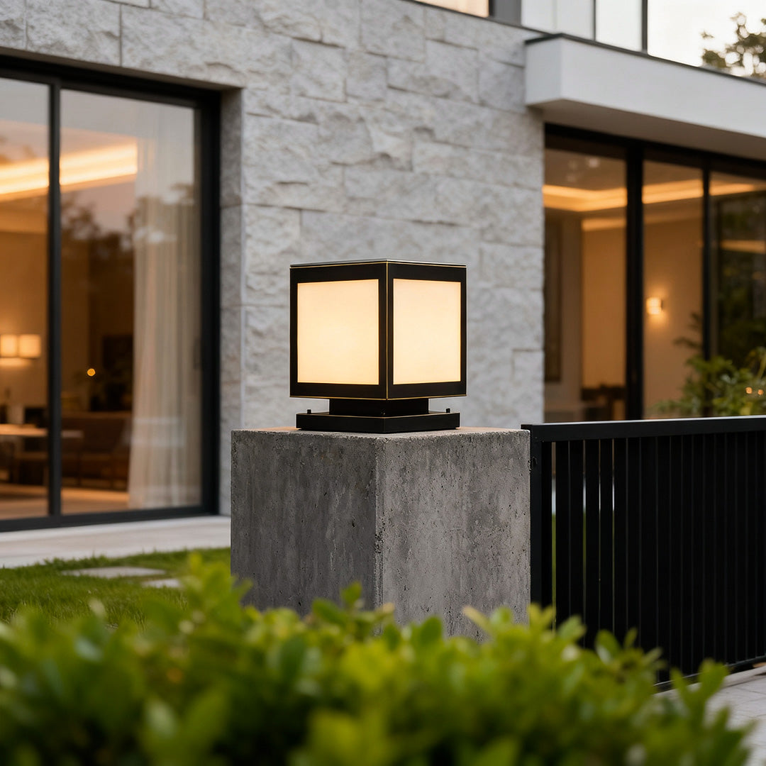 Sleek pillar solar light mounted on a stone pillar, enhancing the ambiance of a lush garden.