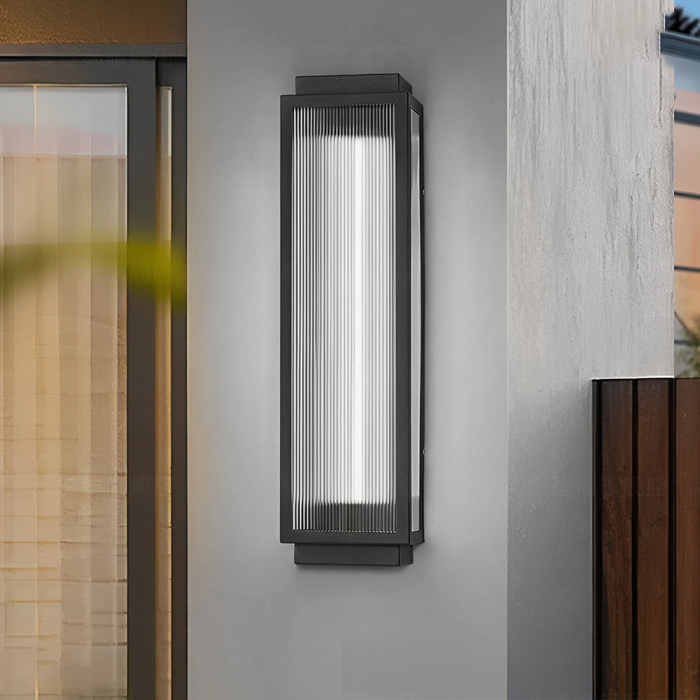 Sleek reeded glass light installed above a wooden door, blending modern design with natural elements.