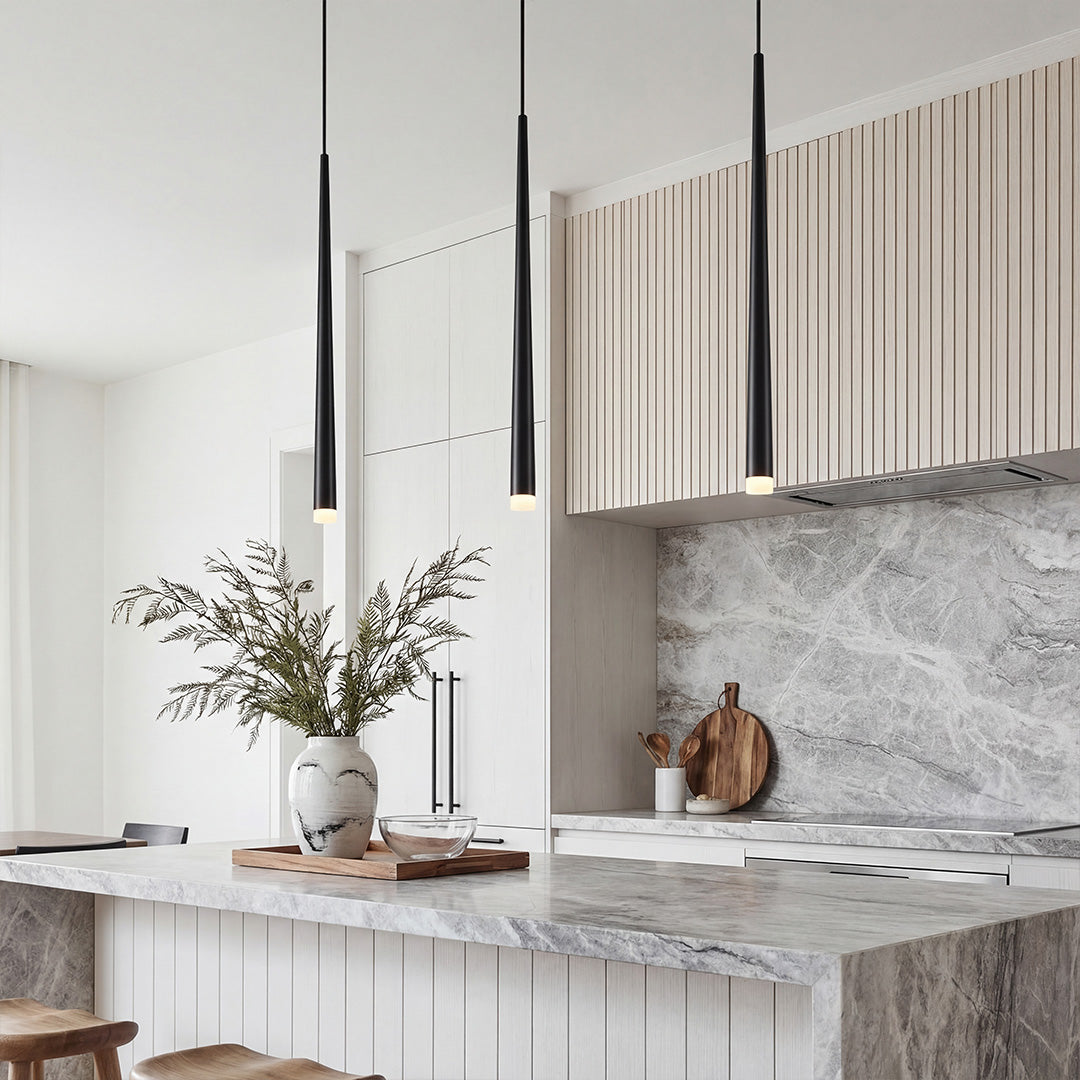 Trio of sleek Slim Black Pendant Light fixtures hanging over a luxury marble kitchen island.