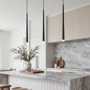 Trio of sleek Slim Black Pendant Light fixtures hanging over a luxury marble kitchen island.