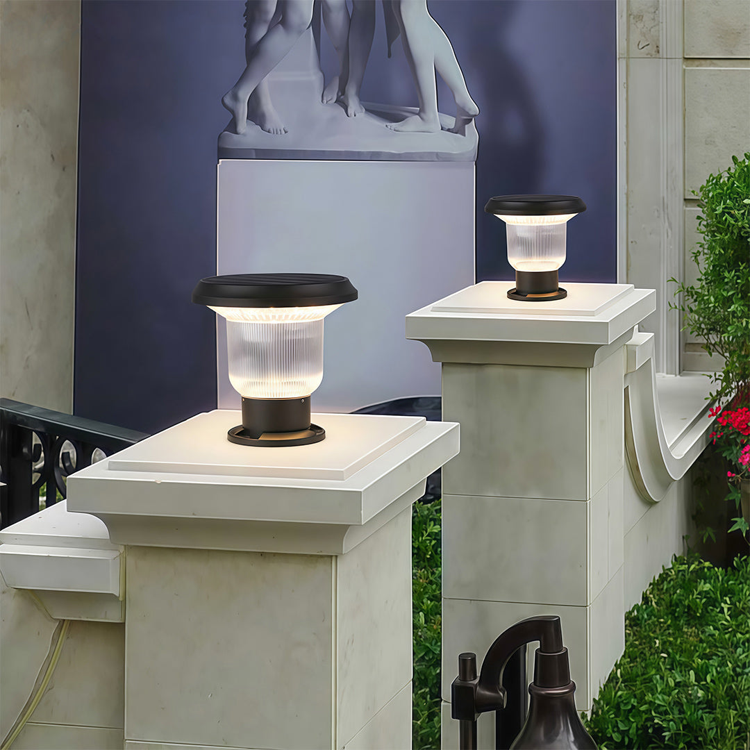 Sleek solar pillar light on a pillar, highlighting a modern outdoor space with warm lighting.