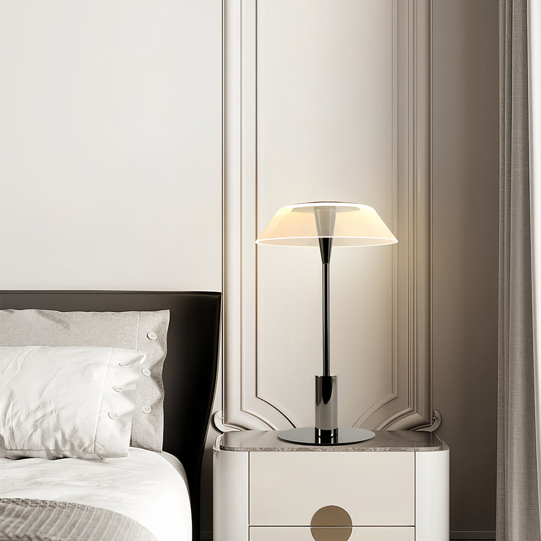 Sleek table lamp with a white translucent shade on a bedside table