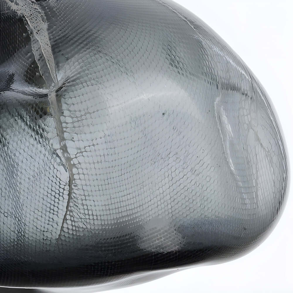 This Transparent Glass Pendant Light is a minimalist Nordic design featuring hand-blown textured glass, ideal for creating warm and inviting lighting in any room.