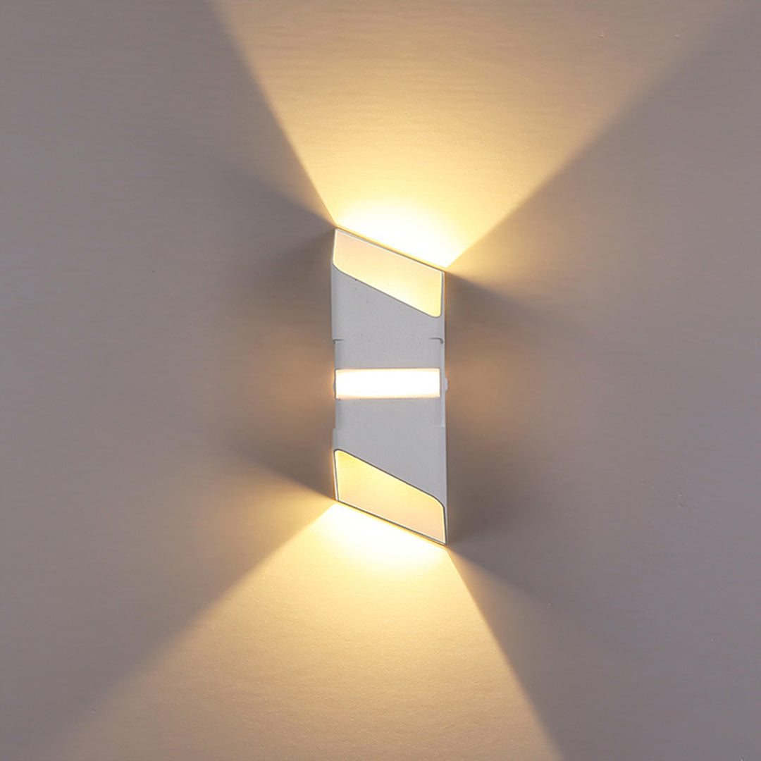 Sleek wall light with silver and gold elements producing geometric light patterns