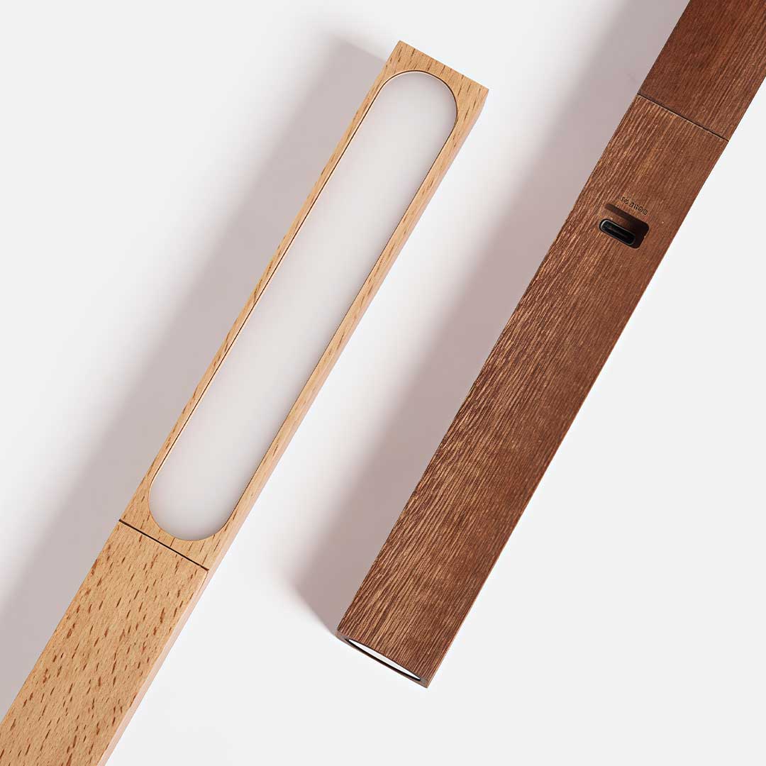 Nordic LED desk light with a slender wooden design, providing soft, warm light for a calm and productive workspace.