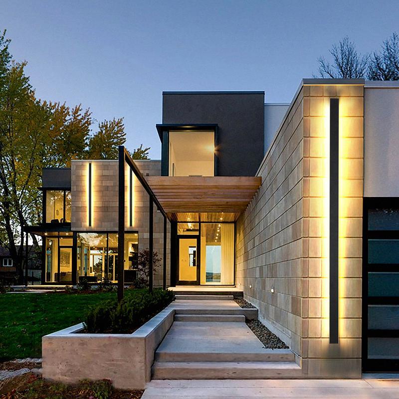 Slim linear outdoor wall sconce with warm LED glow, mounted on modern concrete exterior for sleek illumination.