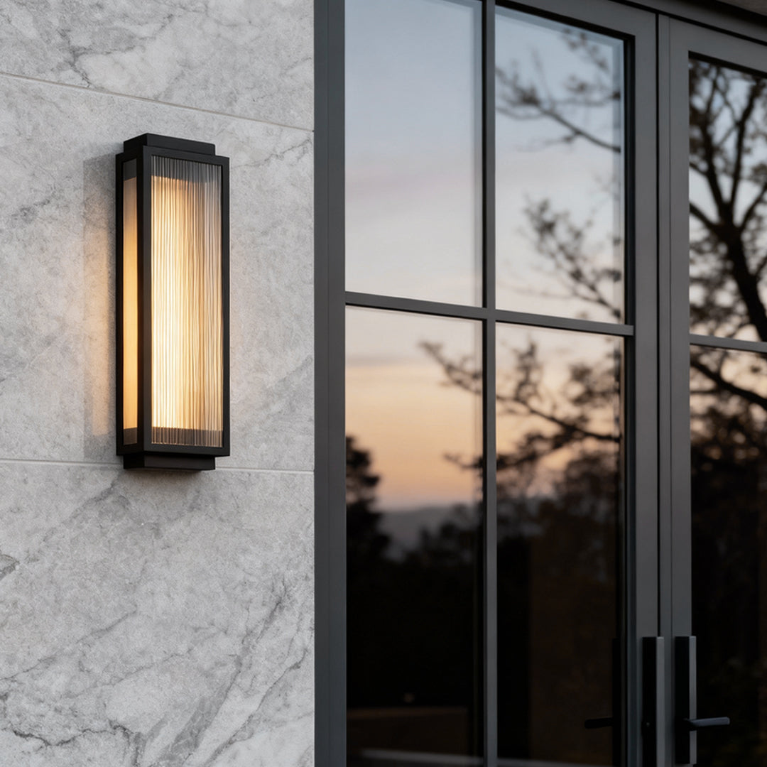 Slim reeded glass light mounted on a marble wall, offering a contemporary and elegant outdoor lighting solution.