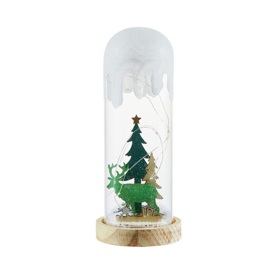 Tall slim snow-globe style decor light with tree silhouette, resembling a festive white glass table lamp.