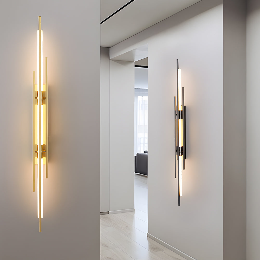 Slim vertical tube wall sconce installed on hallway wall with soft ambient lighting.
