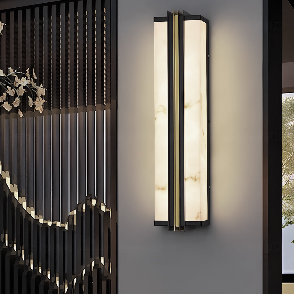 Slim vertical wall light with marble texture diffuser mounted on contemporary exterior facade.