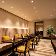 small ceiling spotlights installed in a modern hotel room providing warm ambient lighting and a clean ceiling design