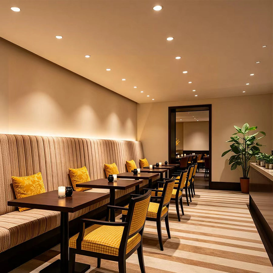 small ceiling spotlights installed in a modern hotel room providing warm ambient lighting and a clean ceiling design