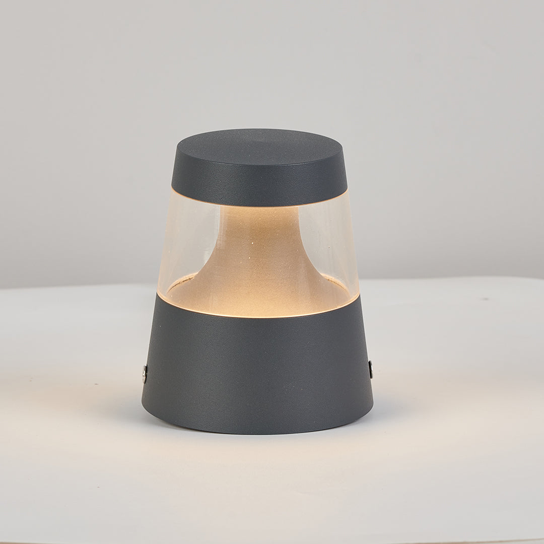 Small landscape lights displayed on a tabletop, emphasizing the compact size and modern outdoor fixture shape.