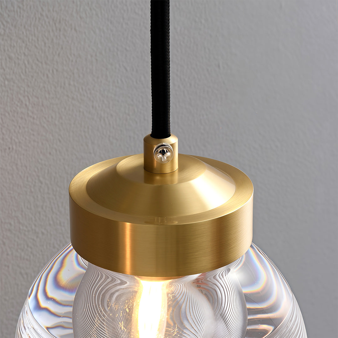 Modern luxury chandeliers close-up showcasing brass finish and ribbed glass detail