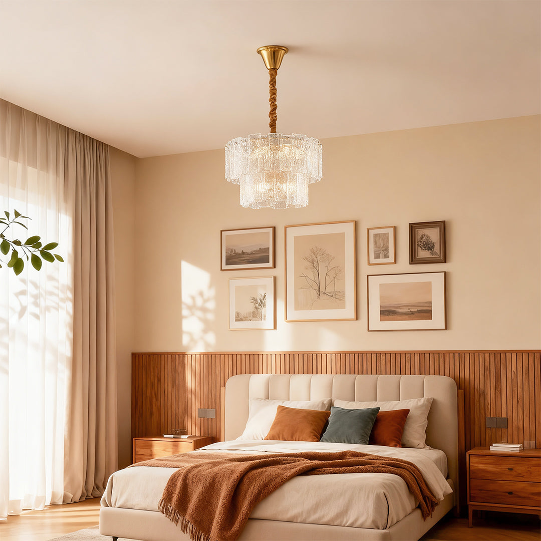 Small modern chandeliers above warm bedroom with wood slat headboard and gallery wall art