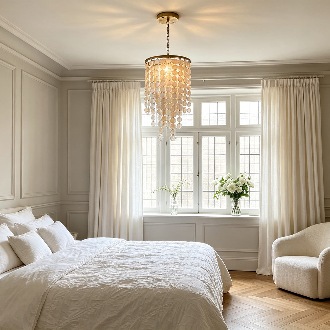 Small staircase chandelier featuring layered glass discs and warm lighting in a bedroom space.