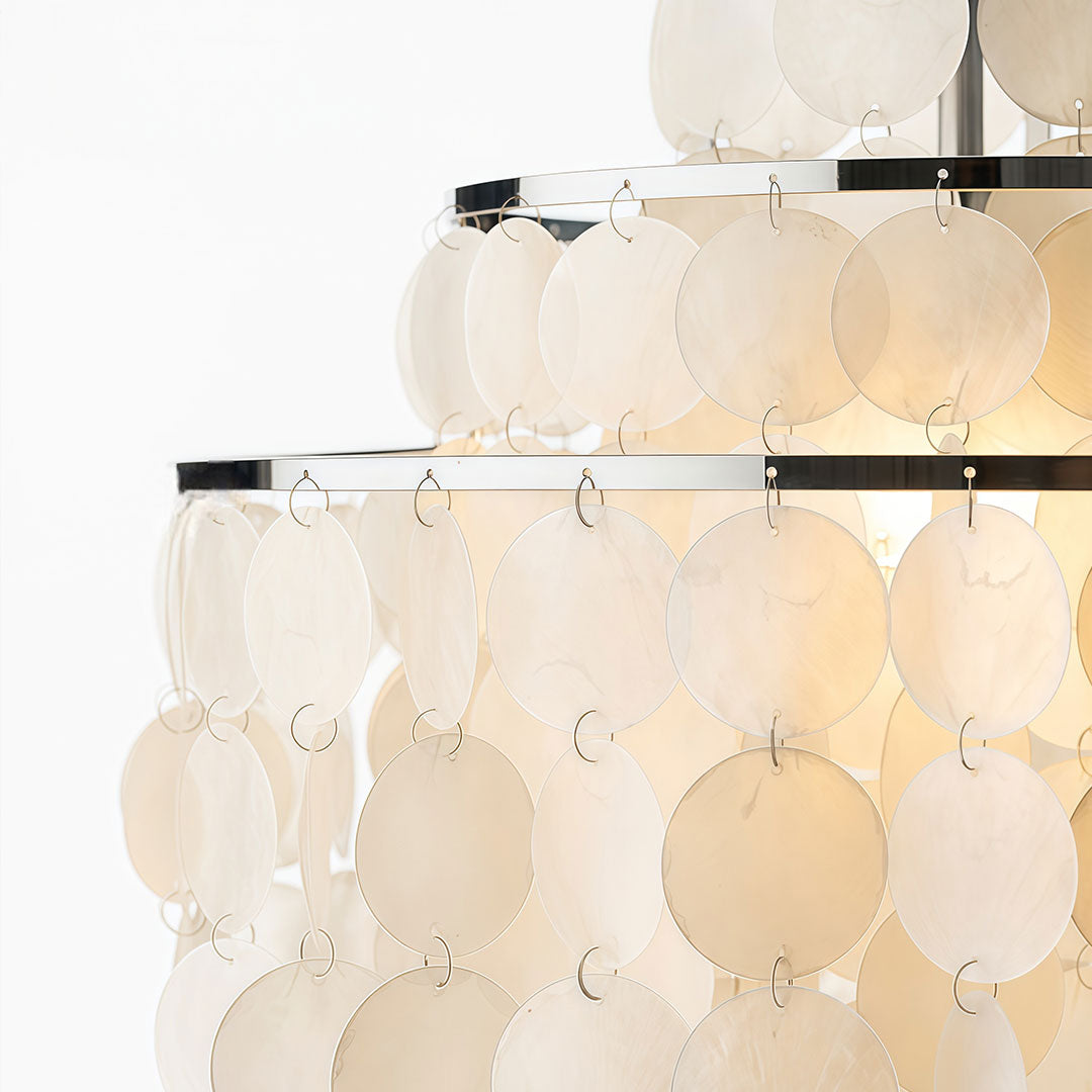 Small staircase chandelier featuring multiple layers of round glass panels and a decorative hanging style.