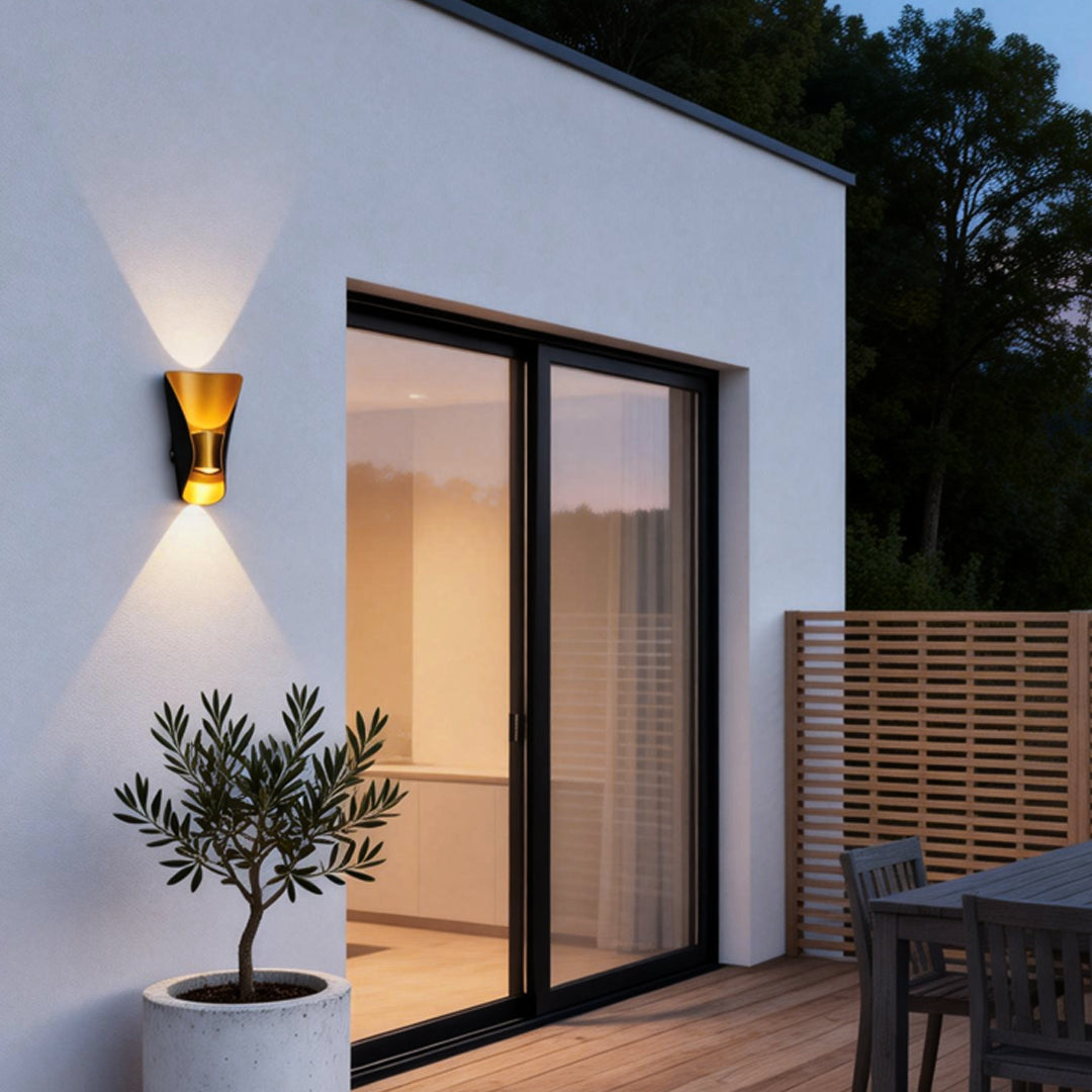 Small up down wall lights illuminating a modern house entrance with warm directional glow.