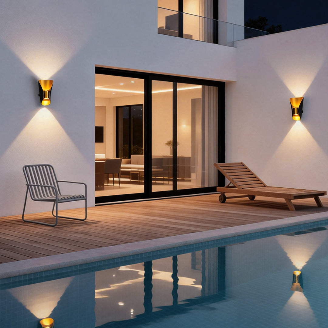 Small up down wall lights providing soft illumination beside a pool area.