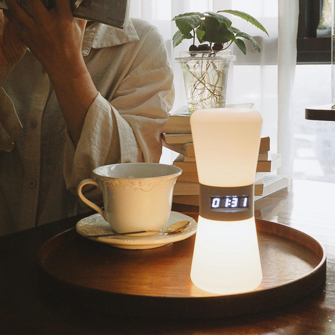 Small white USB rechargeable table lamp with coffee cups creating intimate café ambiance