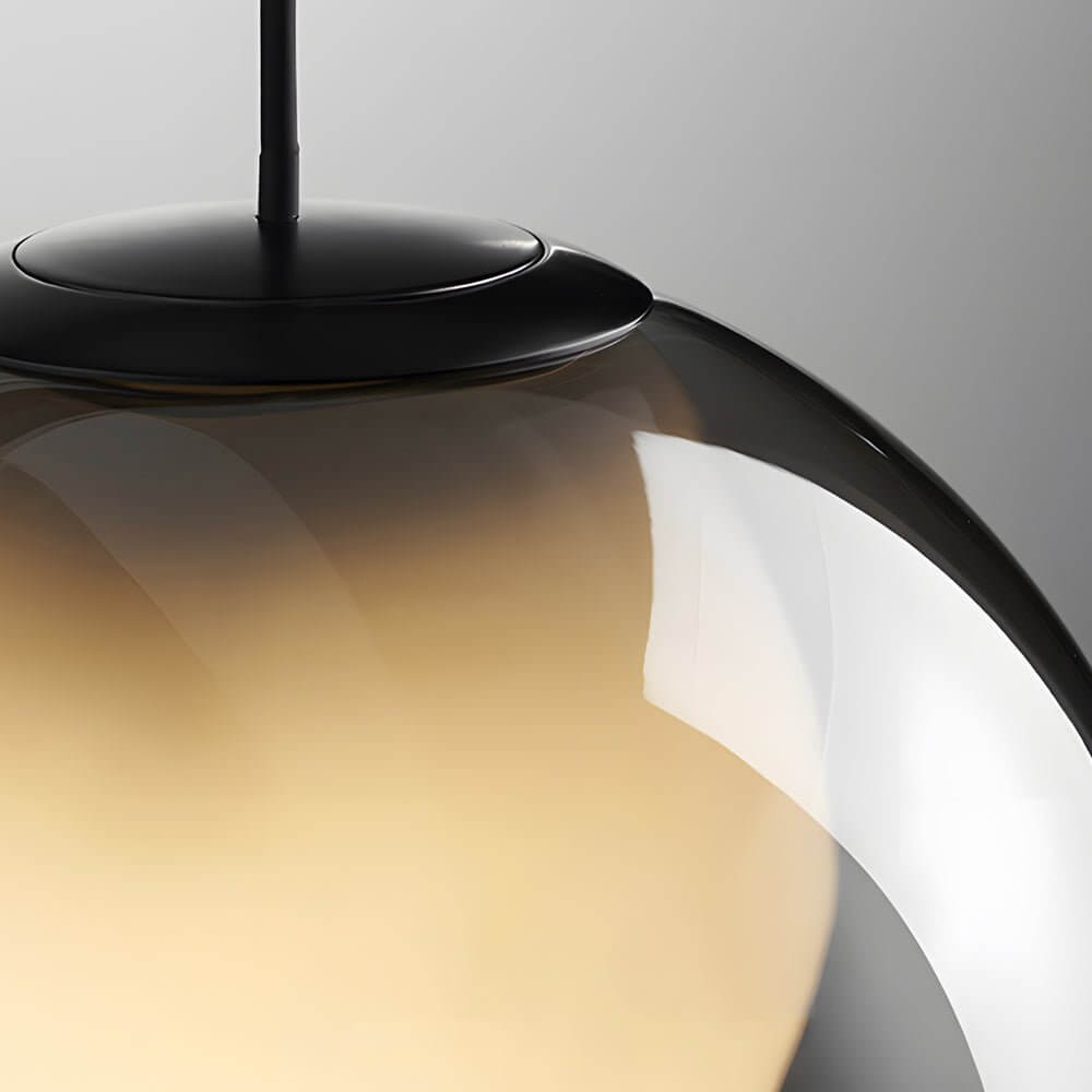 Close up of a smoked glass pendant light showing the matte black hardware and smooth glass curve.