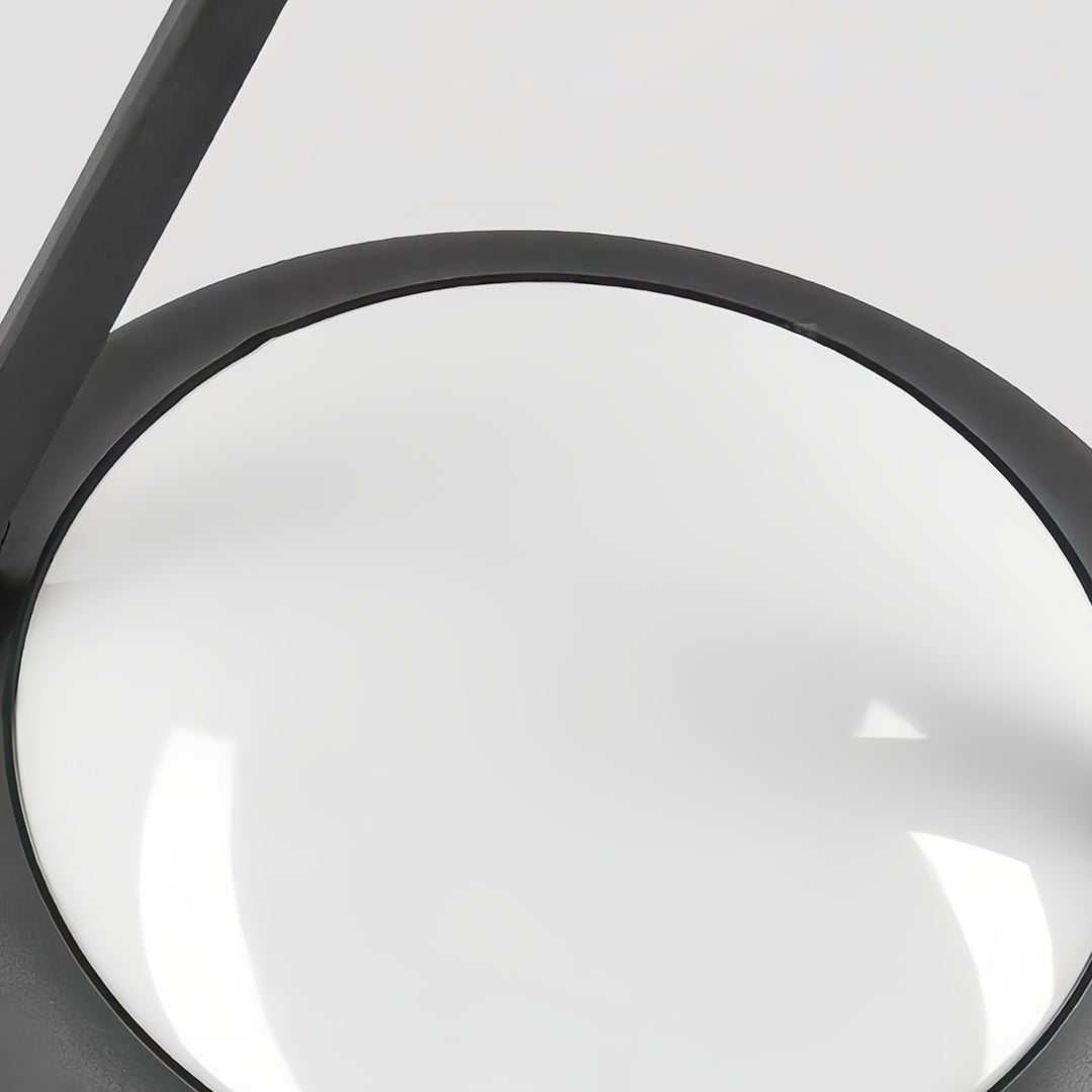 Close-up of the smooth white circular LED diffuser on the modern black external pillar lights fixture.