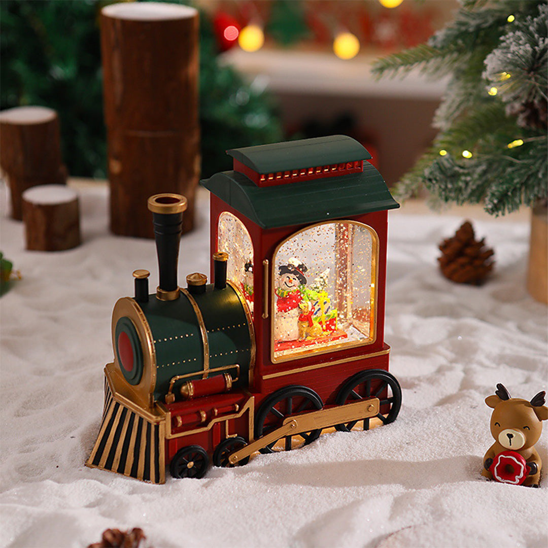 Christmas train light placed on snowy display with illuminated Santa cabin and festive background.