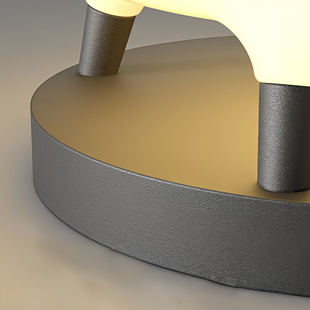 Solar column pillar lights with a round design, mounted on a concrete base for garden illumination.