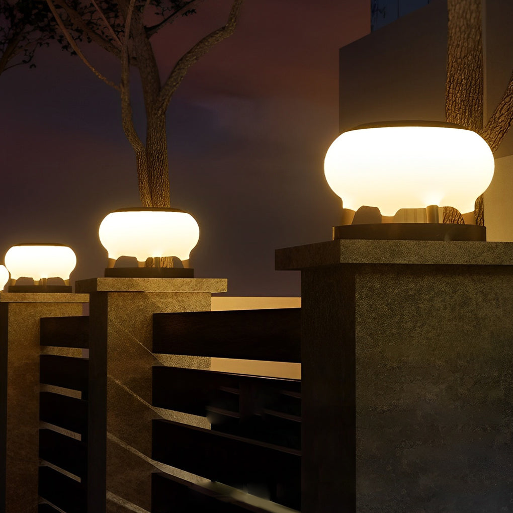 Solar column pillar lights with soft white light, enhancing the ambiance of an outdoor patio area.