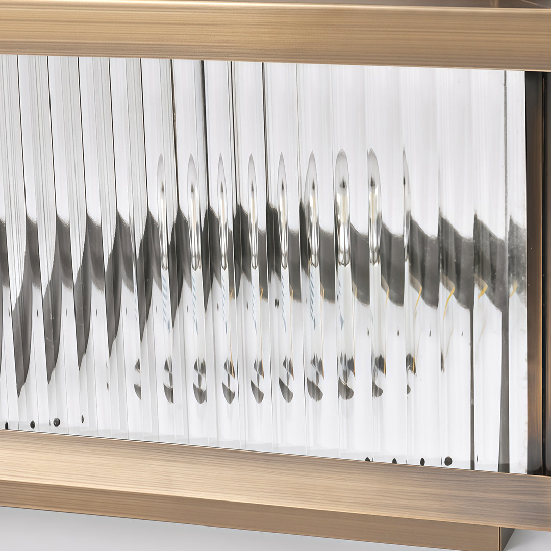 Angled view of copper pillar lights showing solar panel top and warm corrugated glass construction