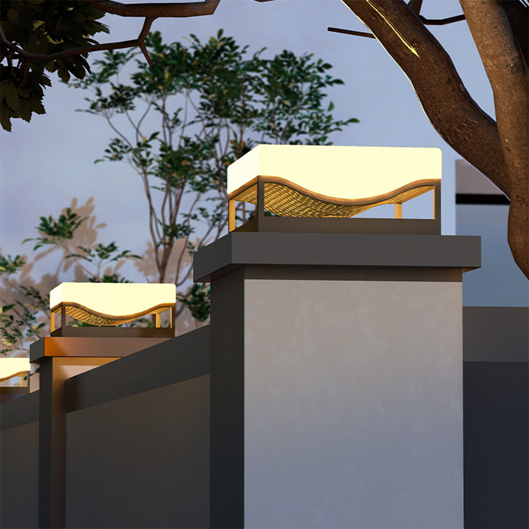 Solar deck lights installed on concrete pillars creating warm ambient lighting at dusk