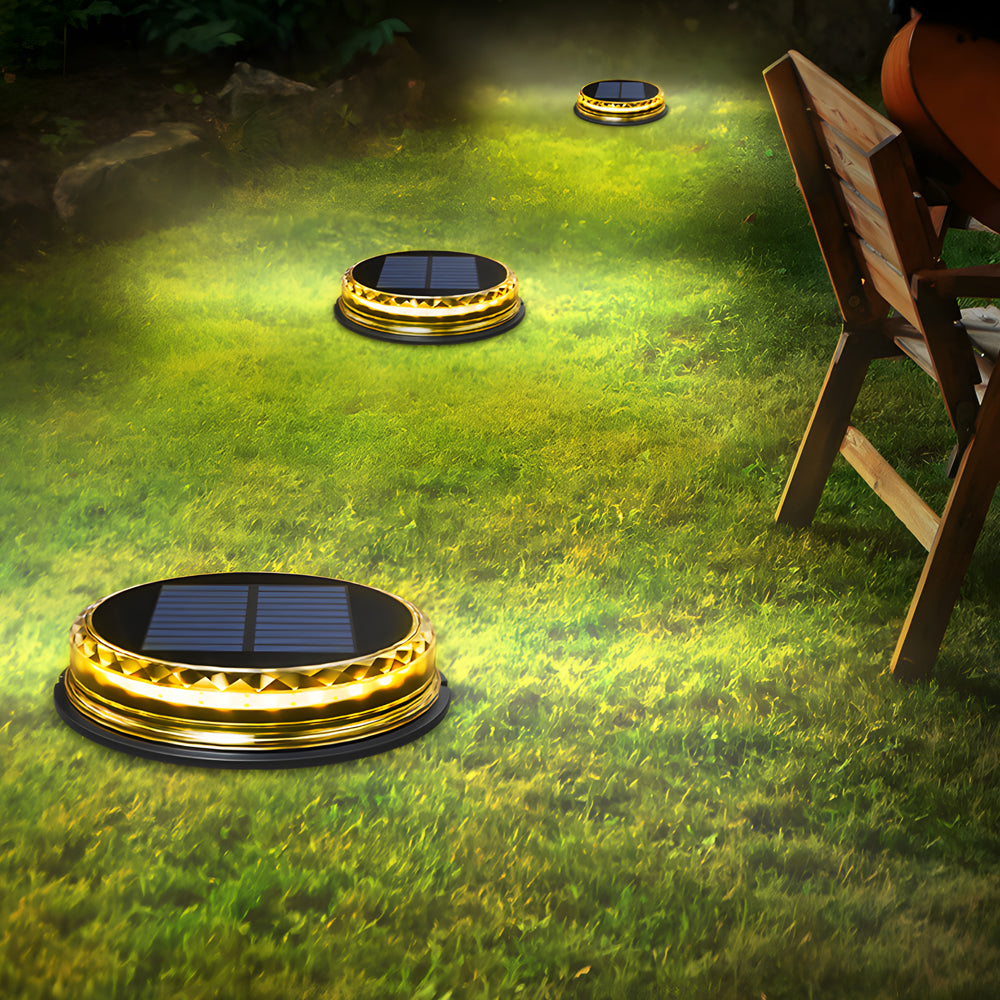 Solar disc light with a close-up of its illuminated surface on green grass.