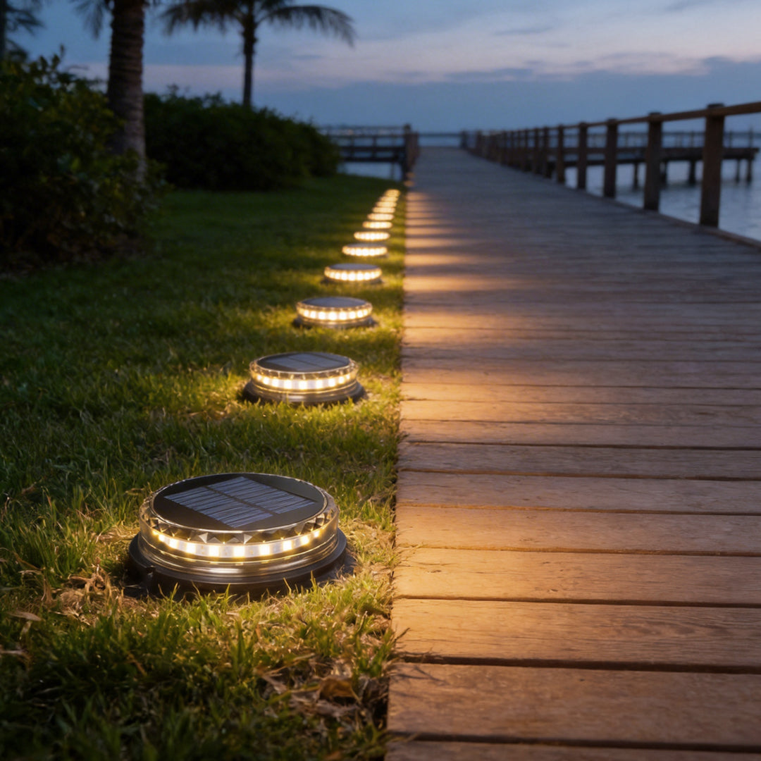 Solar disc light illuminating a garden pathway with warm glow, creating a cozy ambiance.