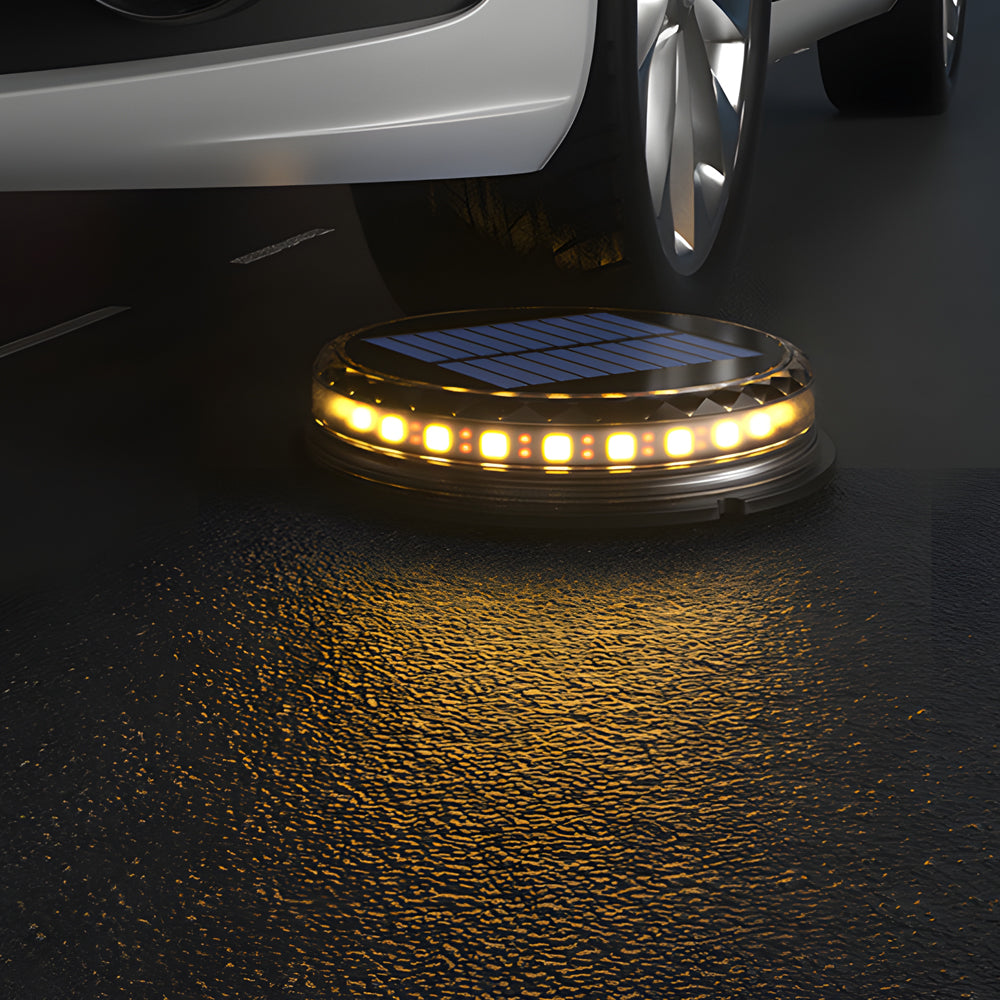 Solar disc light under a car, highlighting its durable and waterproof design.