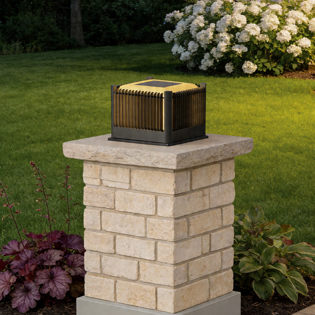 Solar driveway pillar lights installed on brick garden column creating stylish landscape illumination.