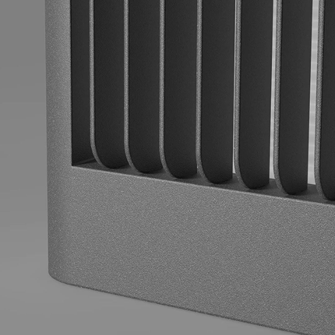 Close-up detail of solar driveway pillar lights showing textured vertical metal frame design.