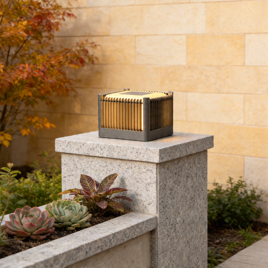 Solar driveway pillar lights mounted on stone entrance pillar with elegant modern outdoor lighting.