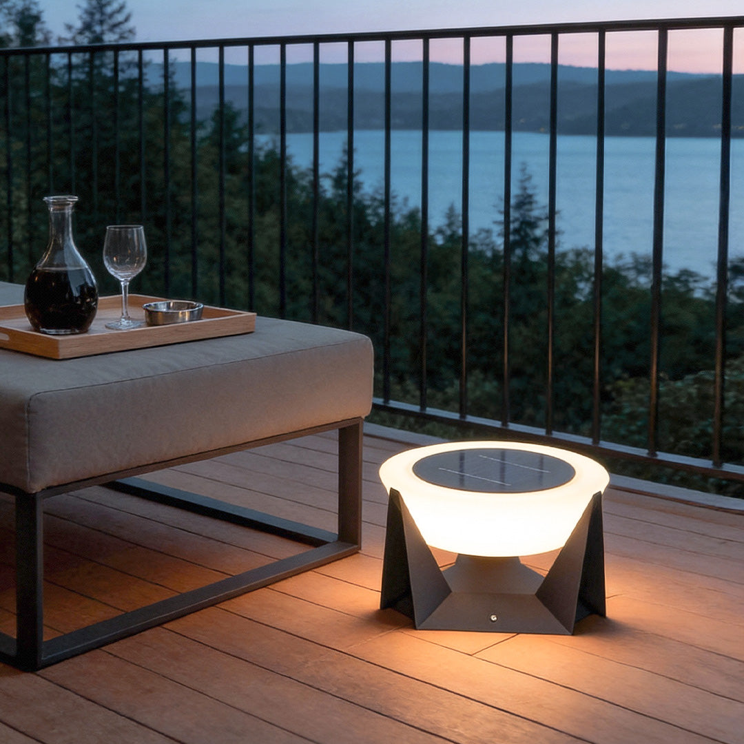 Solar fence pillar light on a balcony deck, creating warm accent lighting with scenic evening views.