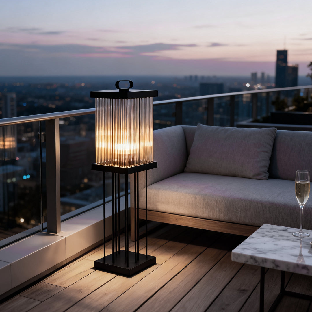 Modern solar garden lantern illuminating a balcony seating area at dusk.
