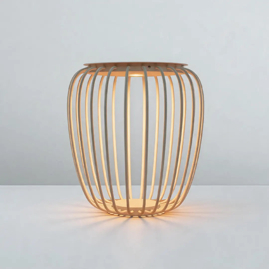 Solar garden lantern with an open-frame design and warm glow shown on a light background.